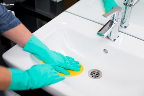 Carpet cleaner wearing PPE during a safe cleaning job in Isle Of Dogs