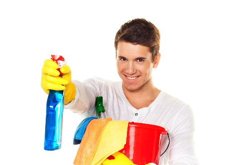 Technician applying stain removal solution to a carpet area